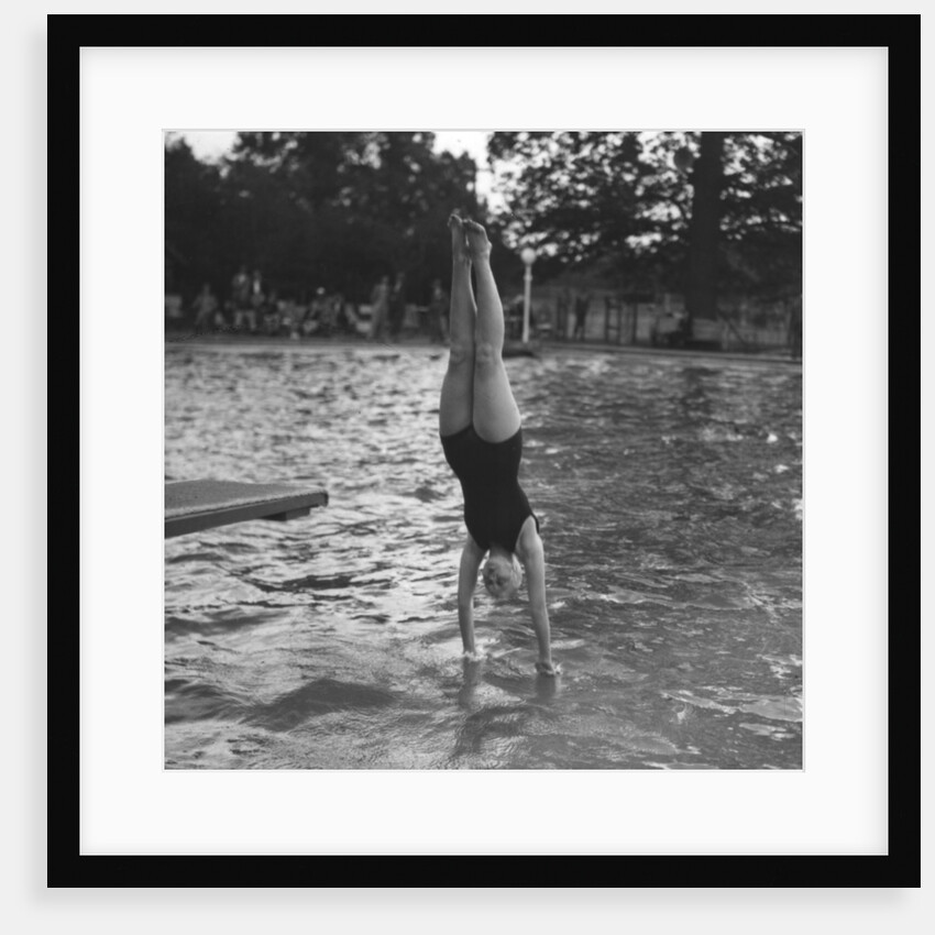 Woman diving into a swimming pool by Anonymous