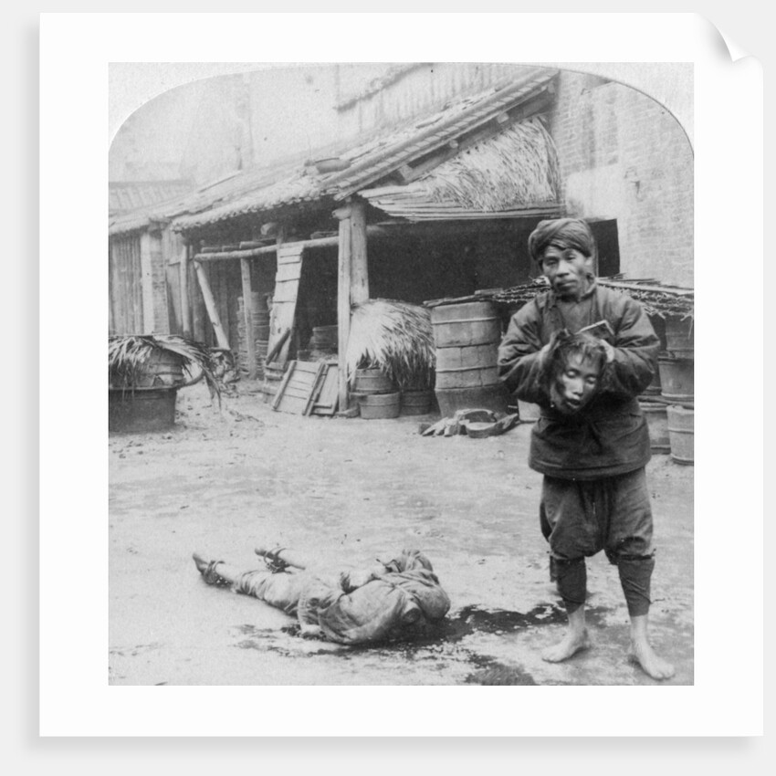 The grim executioner taking the labled head to exhibit a warning by Underwood & Underwood