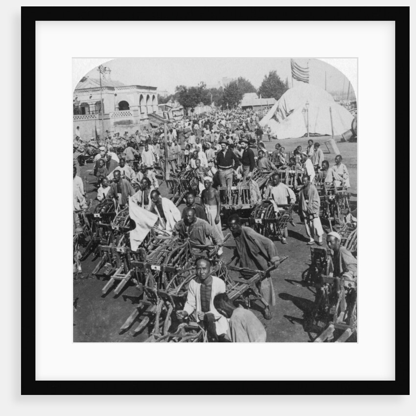 Wheelbarrow transportation at the boat landing by Underwood & Underwood