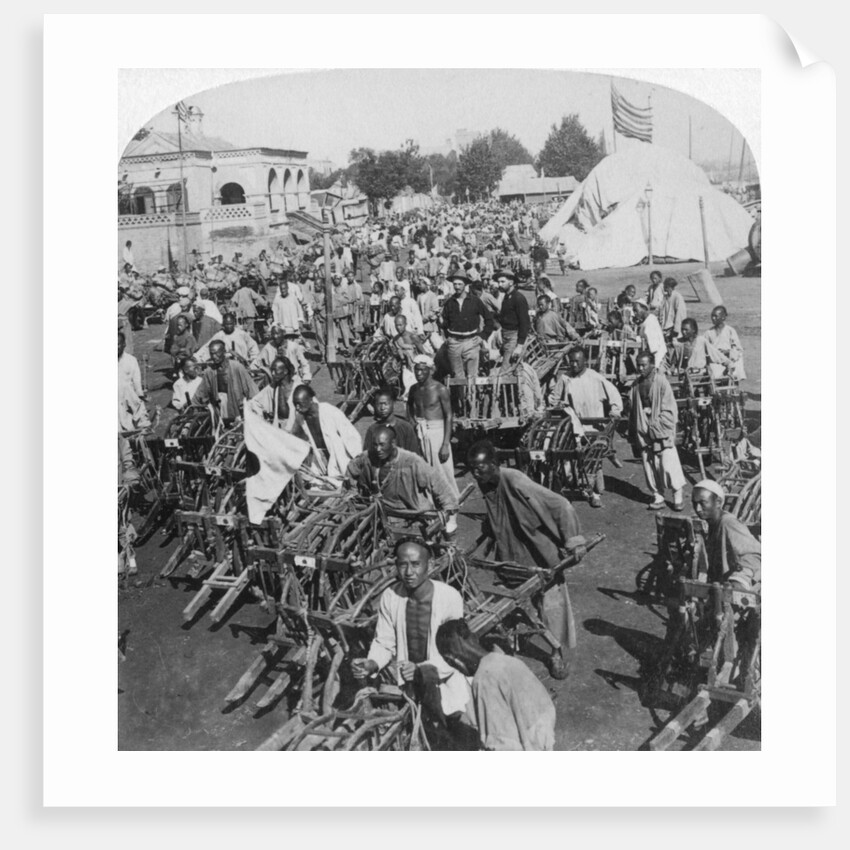 Wheelbarrow transportation at the boat landing by Underwood & Underwood