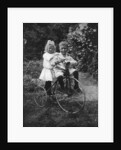 Two children on a tricycle by CW Perry