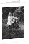Two children on a tricycle by CW Perry