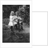 Two children on a tricycle by CW Perry