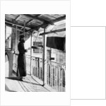 Monk sounding the call to prayer on a gong, Greece by Nomias