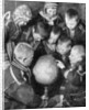 Lapp children looking at a globe by Anonymous