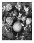 Lapp children looking at a globe by Anonymous