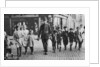 Policeman helping schoolchildren across the road, East End, London by Anonymous