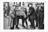 Street hawker selling football favours in King's Cross, London by Anonymous