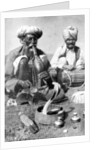 Charming the venom from a cobra; a snake charmer with a mongoose, India by JH Powell