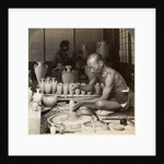 A potter and his wheel, fashioning a vase of Awata porcelain, Kinkosan works, Kyoto, Japan by Underwood & Underwood