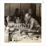 A potter and his wheel, fashioning a vase of Awata porcelain, Kinkosan works, Kyoto, Japan by Underwood & Underwood