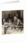A potter and his wheel, fashioning a vase of Awata porcelain, Kinkosan works, Kyoto, Japan by Underwood & Underwood