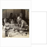 A potter and his wheel, fashioning a vase of Awata porcelain, Kinkosan works, Kyoto, Japan by Underwood & Underwood