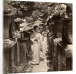 A woman Shinto devotee counting the stone lanterns, Kasuga Shrine, Nara, Japan by Underwood & Underwood