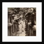 A woman Shinto devotee counting the stone lanterns, Kasuga Shrine, Nara, Japan by Underwood & Underwood