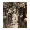 A woman Shinto devotee counting the stone lanterns, Kasuga Shrine, Nara, Japan by Underwood & Underwood