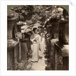 A woman Shinto devotee counting the stone lanterns, Kasuga Shrine, Nara, Japan by Underwood & Underwood