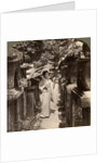 A woman Shinto devotee counting the stone lanterns, Kasuga Shrine, Nara, Japan by Underwood & Underwood