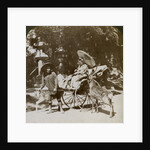 Girl feeding sacred deer on her way to prayers, grounds of Kasuga Temple, Nara, Japan by Underwood & Underwood