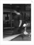 Woman walking past a Rolls-Royce by Anonymous