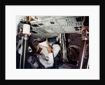 An astronaut inside a NASA Command Module by NASA