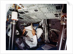 An astronaut inside a NASA Command Module by NASA