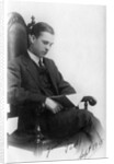 Man sitting in a chair reading a book by Anonymous