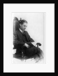 Man sitting in a chair reading a book by Anonymous