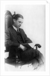 Man sitting in a chair reading a book by Anonymous