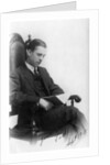 Man sitting in a chair reading a book by Anonymous