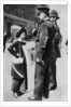 A suffragette confronting two policemen by Sport & General