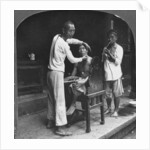 A Chinese barber at Bhamo, Burma by Stereo Travel Co