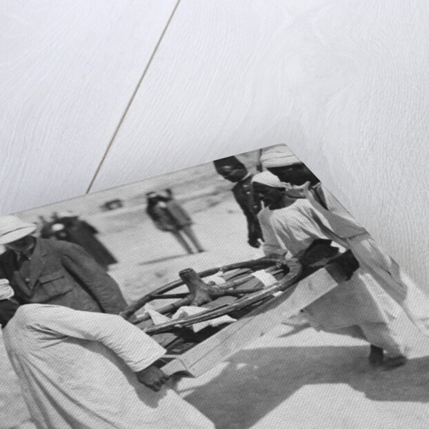 Removing a chariot wheel from the Tomb of Tutankhamun by Harry Burton