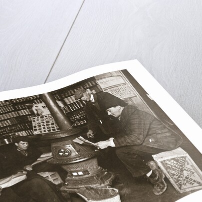 A group of men around a stove in a shop by Anonymous
