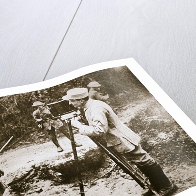Cameraman filming a wounded soldier by Anonymous