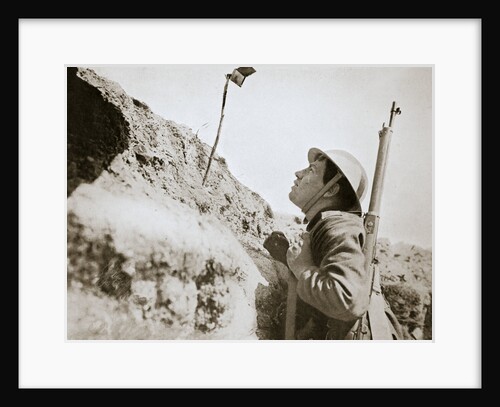 A sentry in the trenches looking through an improvised persicope by Anonymous