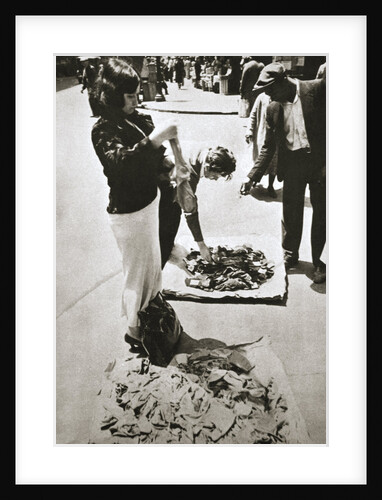 New York street trader selling stockings by Anonymous