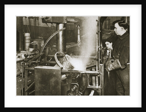 Making money; lowering a pot of liquid metal into a machine by Anonymous