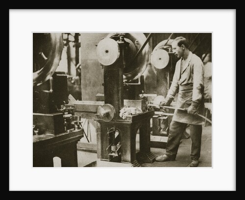 Money making; cutting strips of silver into disks by Anonymous