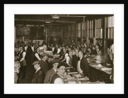 Newsvendors gather to pick up the next day's newspapers to sell by Anonymous