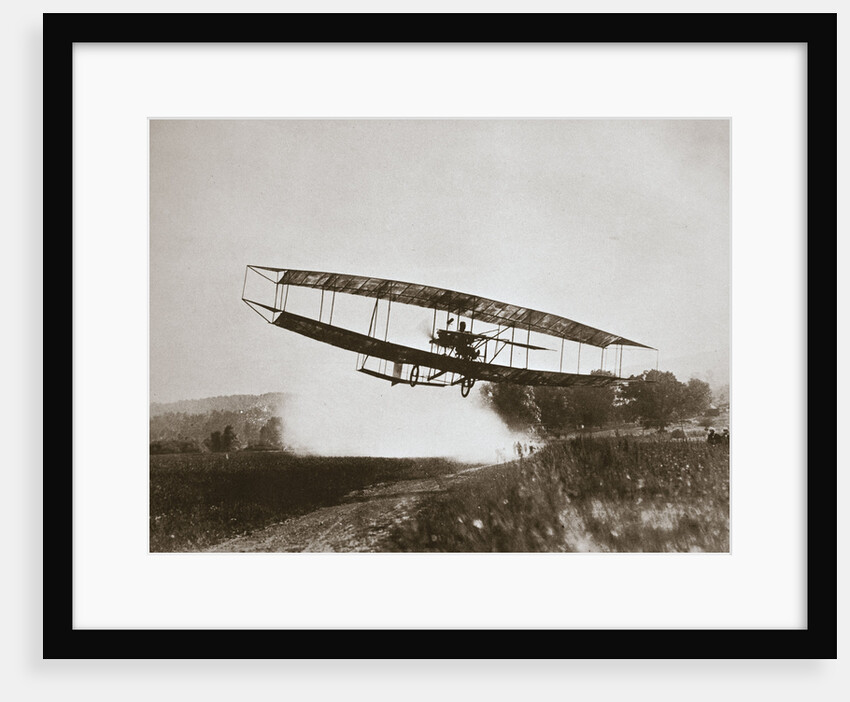 American aviator Glenn Curtiss making the first heavier-than-air flight in his 'June Bug by Edwin Levick