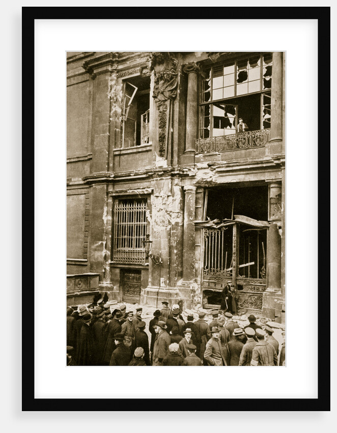 A crowd of men gathered in front of a ruined building by Anonymous
