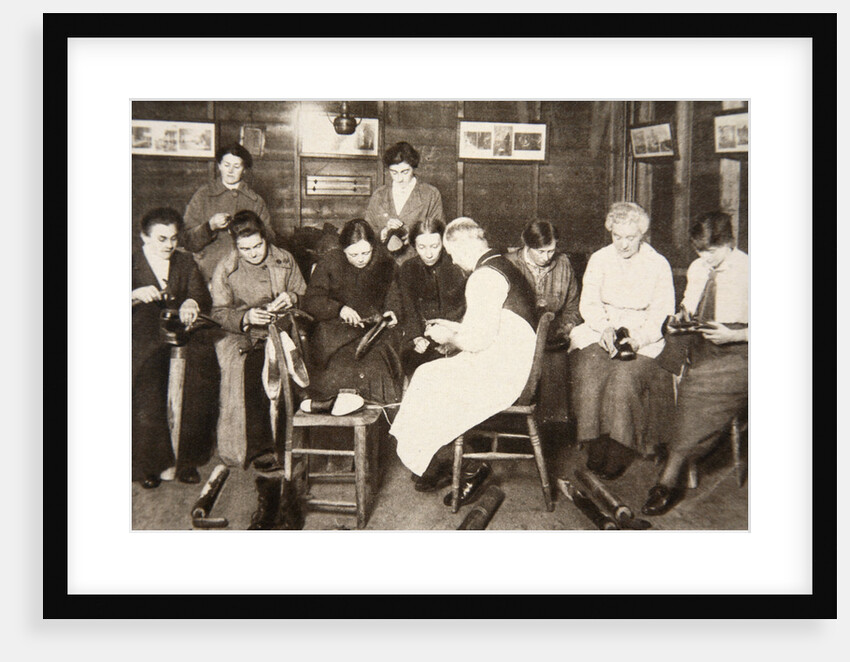 A group of women receive a lesson in boot repairing by S and G