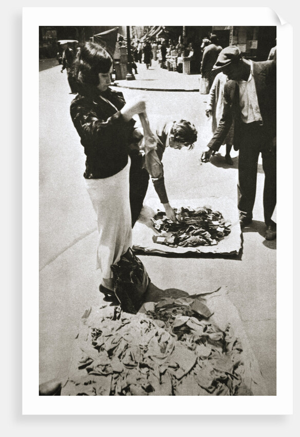 New York street trader selling stockings by Anonymous