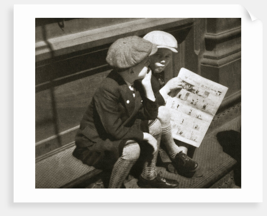 Two boys reading the comic section of the Sunday paper by Anonymous