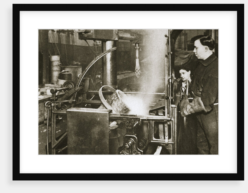 Making money; lowering a pot of liquid metal into a machine by Anonymous
