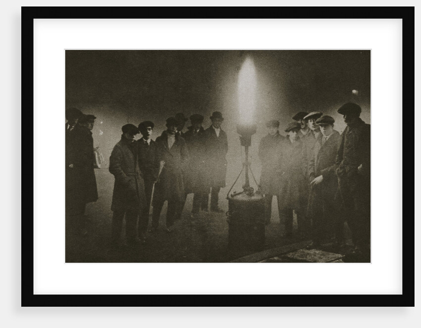 Gathering around an acetylene flare at a traffic control point in the fog by Anonymous