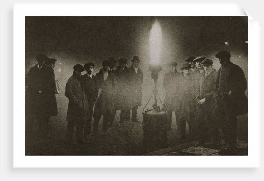 Gathering around an acetylene flare at a traffic control point in the fog by Anonymous