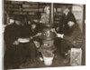 A group of men around a stove in a shop by Anonymous