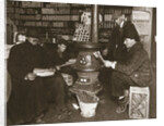 A group of men around a stove in a shop by Anonymous